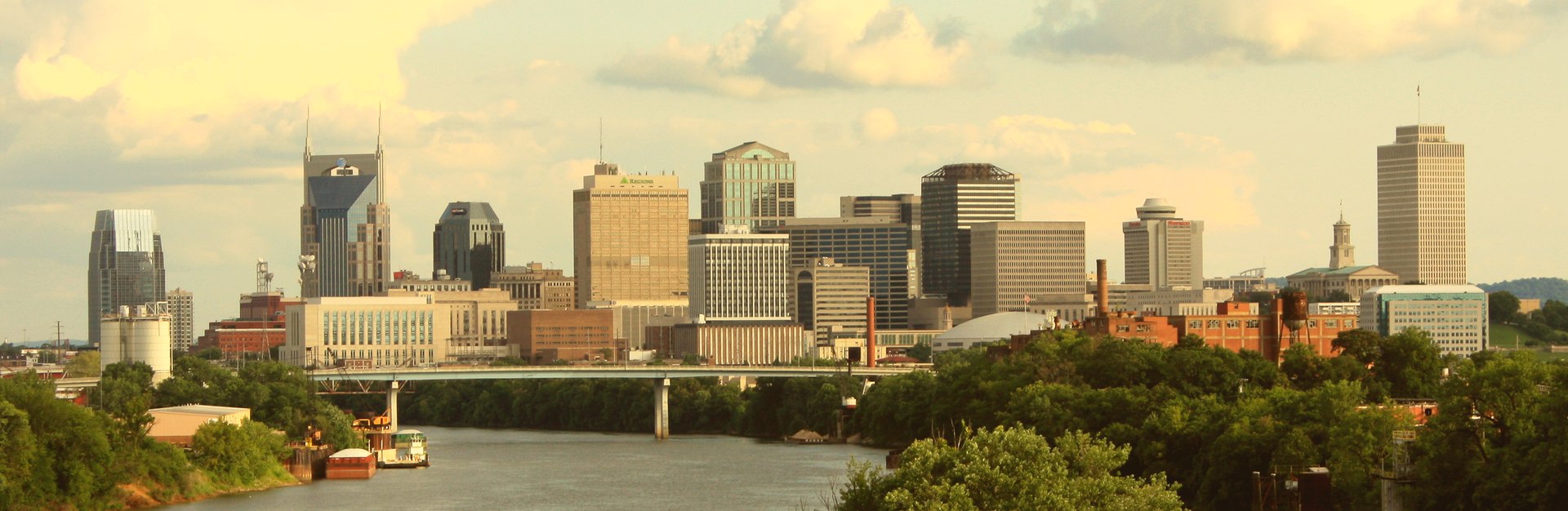 Downtown Nashville, Tennessee skyline at dusk, viewed across the Cumberland River